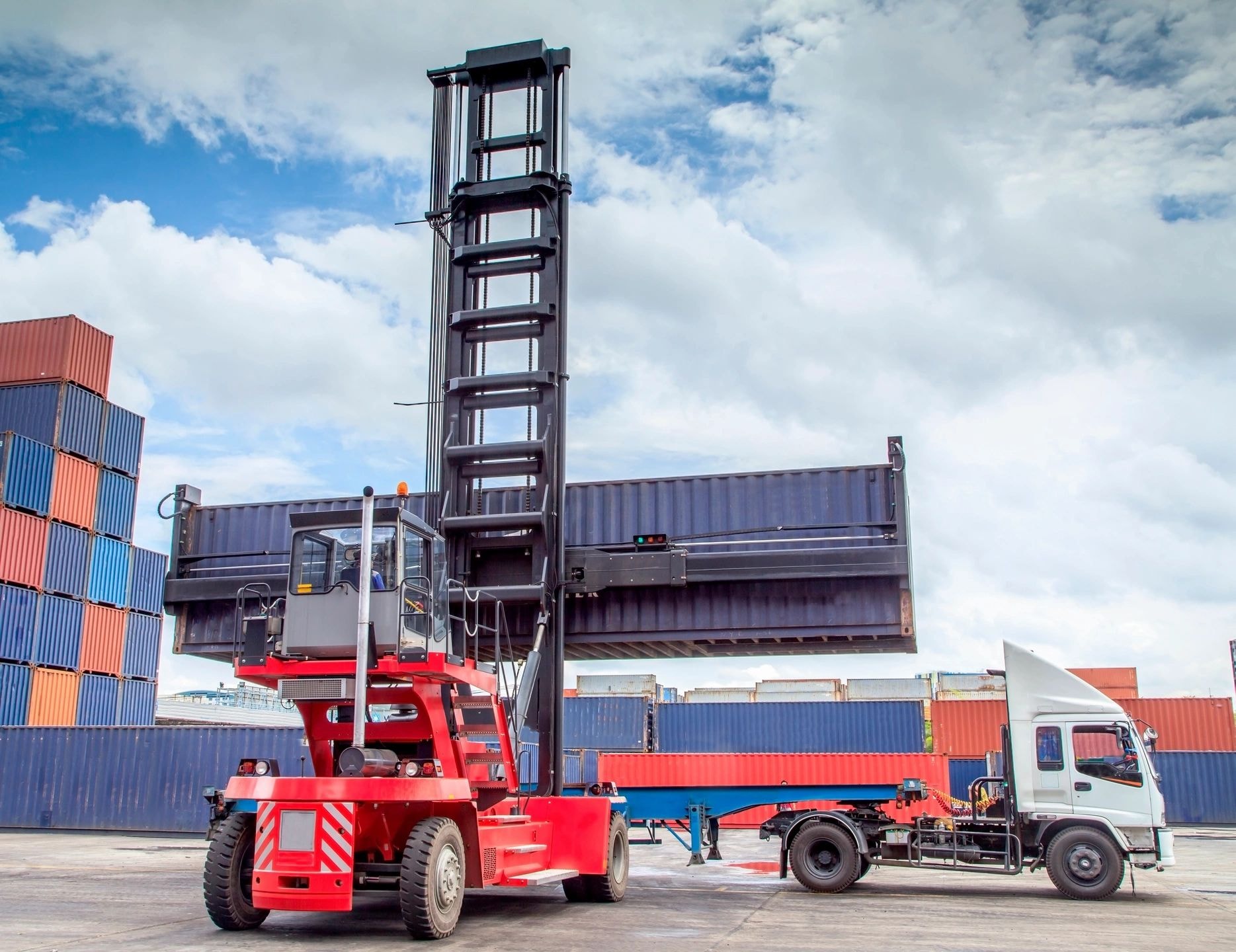 Red container forklift in shipping yard